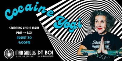 Photo of Andie Main on a black and white swirled background.