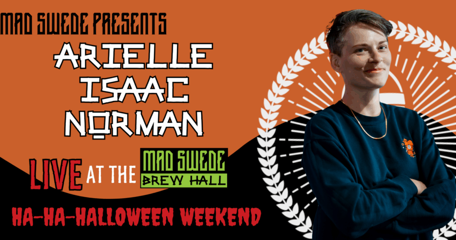 Arielle Isaac Norman posing against a black and orange Halloween backdrop.